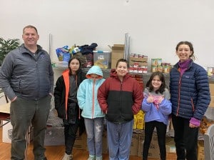 Isabella Culver and Curtis VanEpps with children who received new coats.